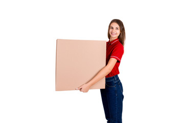 Beautiful girl is delivering a huge parcel to a customer. Smiling woman in work clothes is holding a box isolated on white background