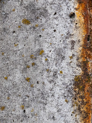 Texture of old reinforced concrete surface with rust and moss. Armored concrete column