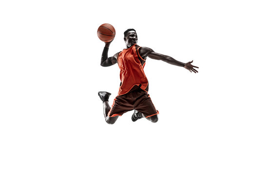 Full length portrait of a basketball player with a ball isolated on white studio background. advertising concept. Fit african american athlete jumping with ball. Motion, activity, movement concepts.