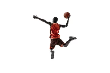 Fototapeten Full length portrait of a basketball player with a ball isolated on white studio background. advertising concept. Fit african american athlete jumping with ball. Motion, activity, movement concepts. © master1305
