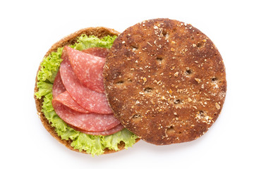 Sandwich with salami sausage on white background.