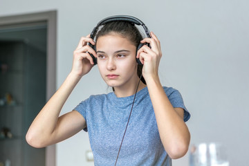 young girl holding headphones on her head