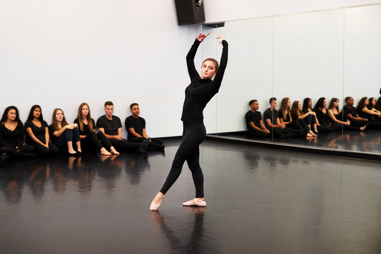Female Ballet Student At Performing Arts School Performs For Class And Teacher In Dance Studio