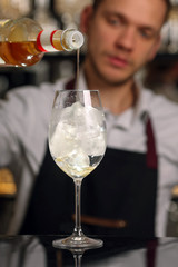 Hugo cocktail drink with ice cubes, mint and lemon