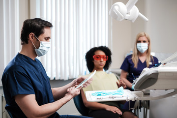 Dentist and his assitant working in private practice