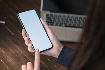 Women's hands holding cell telephone blank copy space screen. smart phone with technology concept.