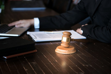 Legal counsel presents to the client a signed contract with gavel and legal law. justice and lawyer concept.