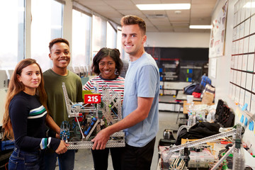 Portrait Of University Students Carrying Machine In Science Robotics Or Engineering Class © Monkey Business