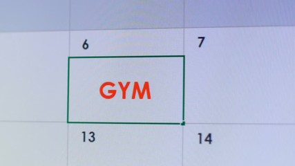 Person typing gym in online calendar planner, workouts and weight loss program