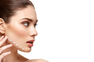 Fototapeta premium girl applying foundation on face isolated on white