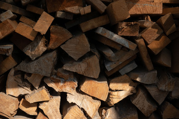 Wooden chopped firewood lies in a pile