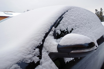 Snowy car in the parking lot