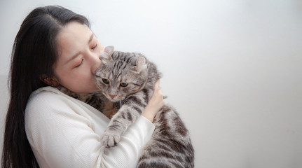 happy cat lovely comfortable sleeping by the woman kissing . love to animals concept .