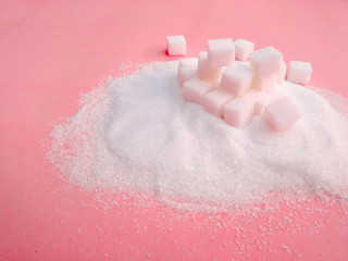 white sugar on the pink table with sugar spread .