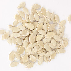 raw superfoods pumpkin seeds on white background