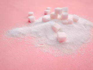 white sugar on the pink table with sugar spread .