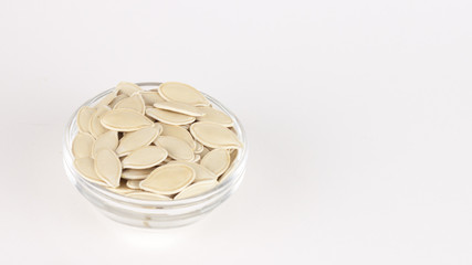 raw superfoods pumpkin seeds on white background