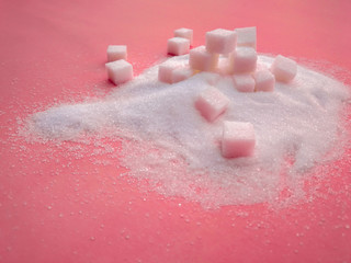 white sugar on the pink table with sugar spread .
