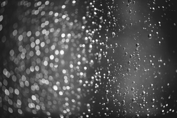 Dirty window glass with drops of rain. Atmospheric monochrome dark background with raindrops....