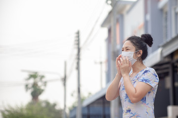 women wearing facial hygienic mask for Safety outdoor. People in masks because of fine dust in thailand. Problems found in major cities around the world. air pollution,Environmental awareness concept