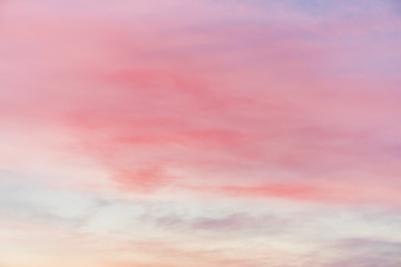 Obraz premium Sunset sky with multicolor light clouds. Colorful smooth sky gradient. Natural background of sunrise. Amazing heaven at morning. Slightly cloudy evening atmosphere. Wonderful weather. Pink dawn clouds