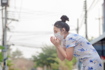 women wearing facial hygienic mask for Safety outdoor. People in masks because of fine dust in thailand. Problems found in major cities around the world. air pollution,Environmental awareness concept