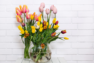 bouquets of tulips in vases on the table