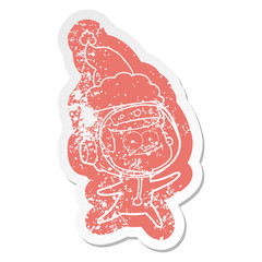 happy astronaut cartoon distressed sticker of a wearing santa hat