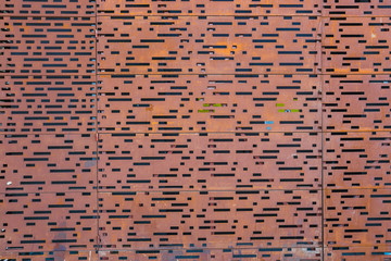 close up of rust coloured facade of a modern building