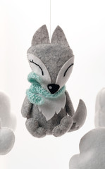 Colorful and eco-friendly children's mobile from felt. A felt toy in the form of a lovely fox, part of a children's mobile. On a white background.