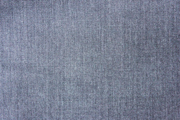 Fototapeta na wymiar Texture background of seamless plain empty jean fabric. Casual grey denim jeans close up top view of straight material cloth piece. Fashion backdrop for copy space, banner or template