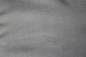 Grunge rough fabric texture background of crumpled grey colored cloth. Surface material design of seamless grain pattern of empty grey backdrop. Blank canvas and copy space template