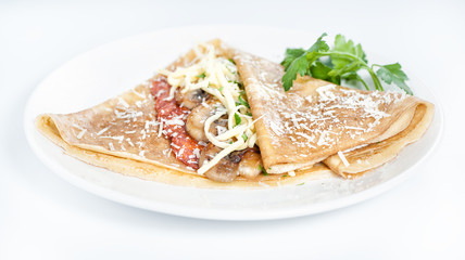 Thin delicious pancake with salami and mushrooms on white