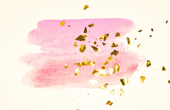 Abstract pink watercolor splash and golden glitter, pieces of foil, background in vintage nostalgic colors.