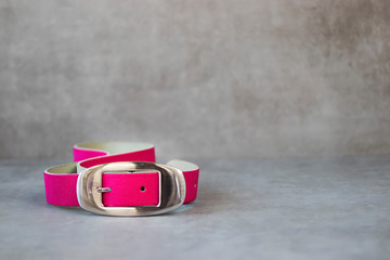 Pink belt on gray background.