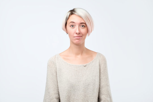 Doubt, mistrust, distrust concept. Doubtful woman looking with disbelief expression at studio.