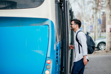 Young traveler getting on the bus.