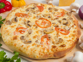 pizza julienne with chicken and mushrooms on a light wooden background