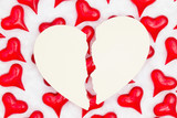 Broken heart card with red hearts on white fabric background