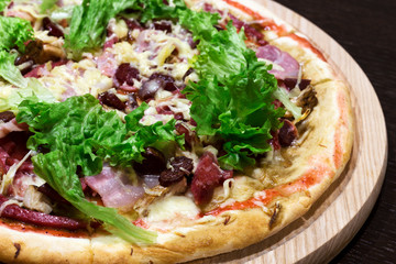 meat pizza with fresh salad, close-up