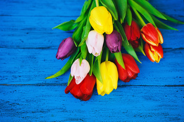 Spring tulips flowers on wooden background