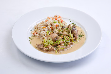meat with vegetables and barley on the white background