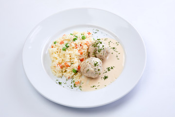 meatballs with rice and vegetables on the white background