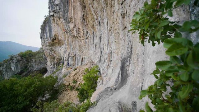 A climber ascending a giant limestone wall in Slovenia