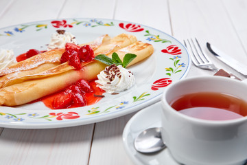 crepes with strawberry sauce and whipped cream