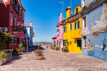 colorful burano island and and blue house with shabby plaster