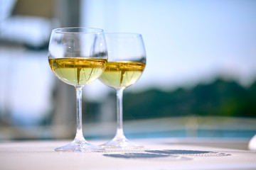Pair of wineglasses against the yacht