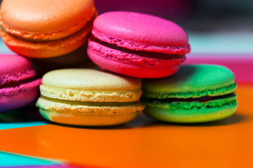 Closeup of macro photo of French dessert, fresh colored macaroons on the table