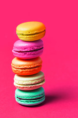 Close up of cake macaron or macaroon on pink