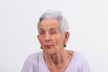 senior woman wink the eye on white background